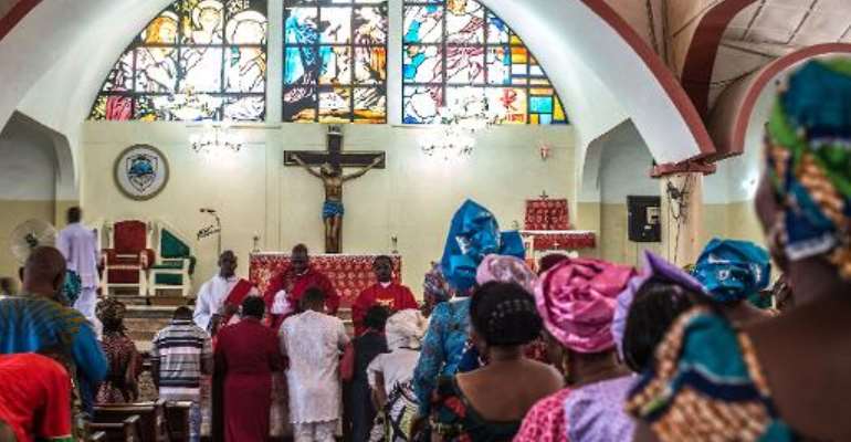 Nigerians attend Sunday mass at Saint Joseph's Cathedral, a rare church in the predominately Muslim area of Kaduna, where peace was preached on March 29, 2015. By Nichole Sobecki (AFP)
