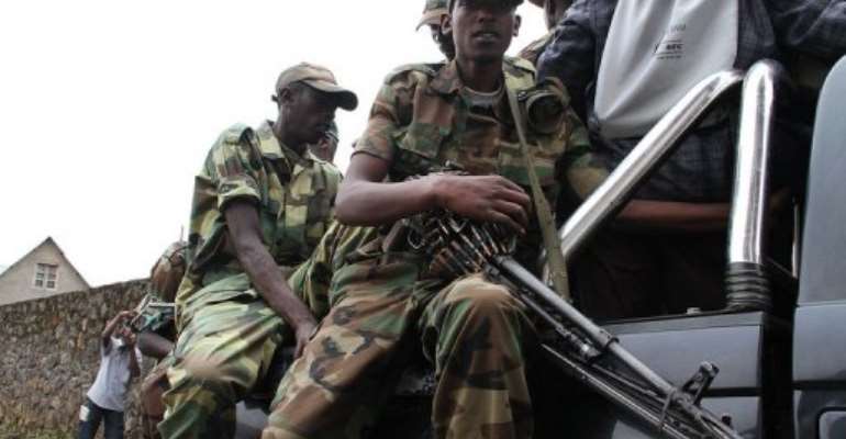 M23 rebels patrol the streets of Bunagana, on January 3, 2013. By Isaac Kasamani (AFP/File)