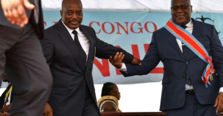 During his inauguration DR Congo's new president, Felix Tshisekedi, (R) walks off the podium with outgoing leader Joseph Kabila in Kinshasa in January 2019. By TONY KARUMBA (AFP/File)
