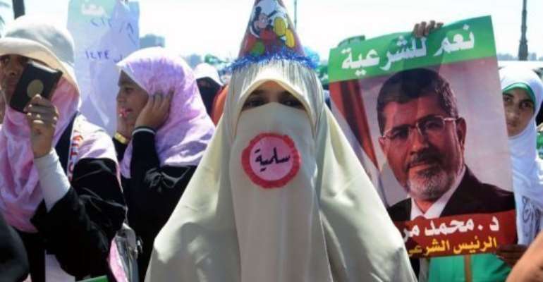 A supporter of Egypt's deposed president Mohamed Morsi attends a demonstration in Alexandria, on August 3, 2013. By (AFP)
