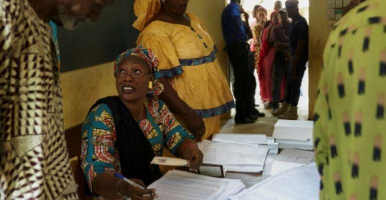 Electoral Commission officials deliver secure voter cards during a distribution in Bamako on June 20, 2018, ahead of the upcoming presidential elections on July 29. By Michele CATTANI (AFP/File)