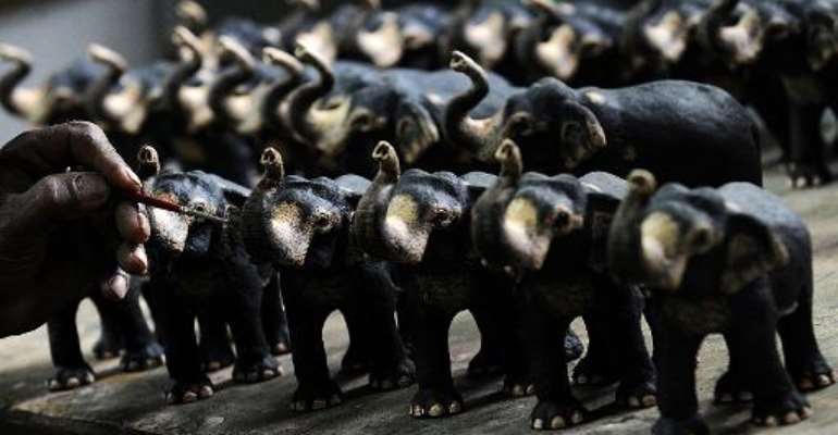 A Sri Lankan artist paints an elephant sculpture made from elephant dung in the village of Pinnawela, some 90kms north-east of Colombo, on July 24, 2013. By Ishara S. Kodikara (AFP/File)