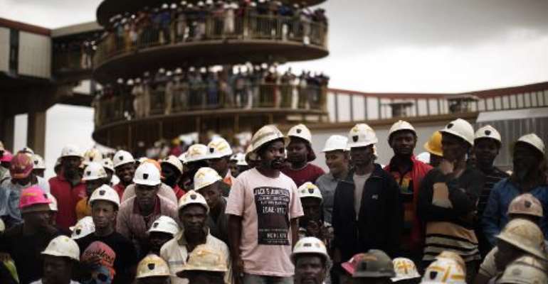 File picture of miners gathered to mourn their colleagues who died in a mining accident in Doornkop, southwest of Johannesburg, on February 6, 2014. By Marco Longari (AFP/File)