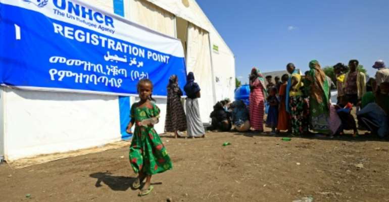 Ethiopian refugees, who have fled the Tigray conflict, queue for food outside UNHCR and World Food Programme tents at a transit centre in Sudan's border town of Hamdayit. By ASHRAF SHAZLY (AFP)