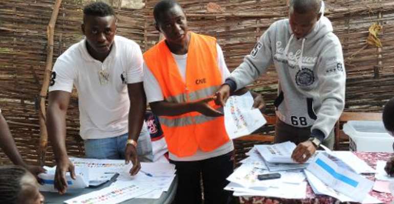 Election officials count ballots at a polling station in Bissau, Guinea-Bissau during national elections on April 13, 2014. By Seyllou (AFP/File)