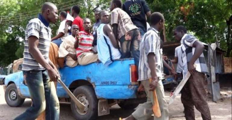 Machete and axe wielding vigilantes on July 19, 2013 in an operation to hunt down Boko Haram Islamists in Maiduguri. By Aminu Abubakar (AFP/File)