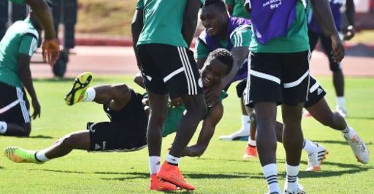 Nigeria's midfielder John Obi Mikel (C) collides with a teammate as they play a game of handball during a training session in Brasilia on June 29, 2014, a day before their match against France at the FIFA World Cup in Brazil. By Jewel Samad (AFP)
