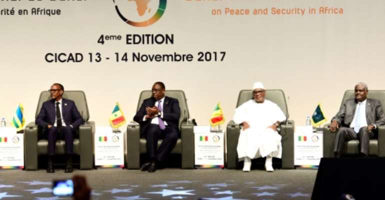(From l) Rwanda's president Paul Kagame, Senegal's president Macky Sall, Mali's president Ibrahima Boubacar Keita and AU Commission head Moussa Faki Mahamat at the opening of the Peace and Security forum in Dakar on Monday. By SEYLLOU (AFP)