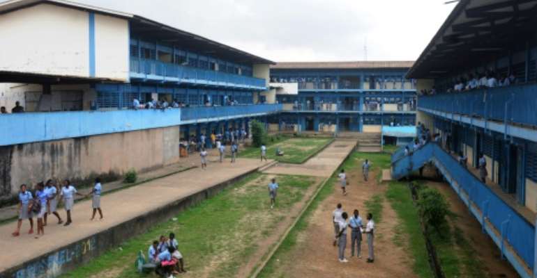 Students standing in the courtyard of their school in Libreville on January 5, 2016 and their daily lives with their parents will be discussed in the African spinoff of the French show