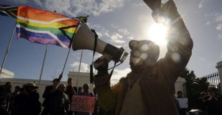 A group of people from the gay, lesbian and transgender community demonstrate in Cape Town in May 2012. By Rodger Bosch (AFP/File)