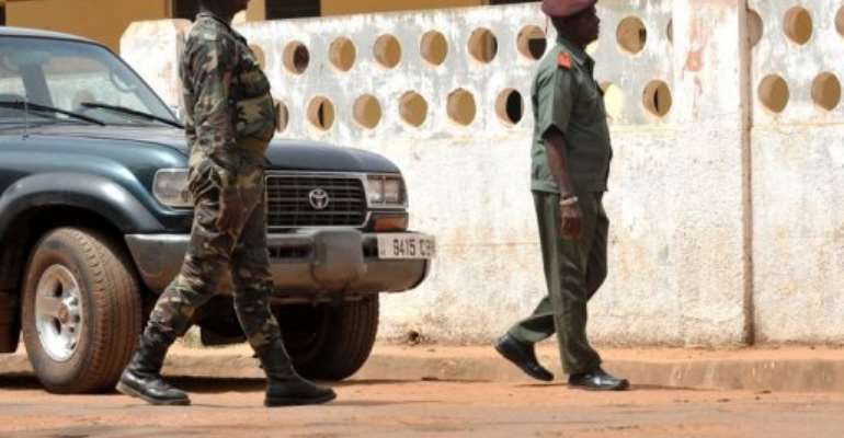 Soldiers stand guard in front of the Army Sporting Club. By Seyllou (AFP/File)