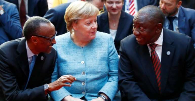 German Chancellor Angela Merkel with Rwanda President Paul Kagame (left) and South African President Cyril Ramaphosa (right). By AXEL SCHMIDT (POOL/AFP)