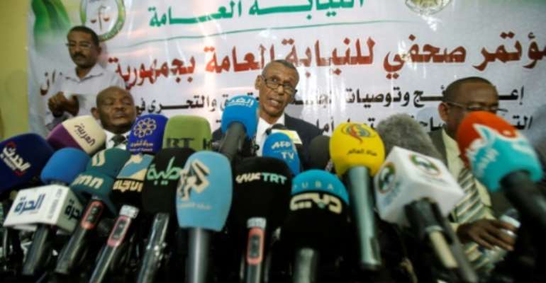 Head of a Sudanese investigative committee Fatah al-Rahman Saeed (C) reveals findings of a probe into the deadly raid on a Khartoum protest camp. By ASHRAF SHAZLY (AFP)