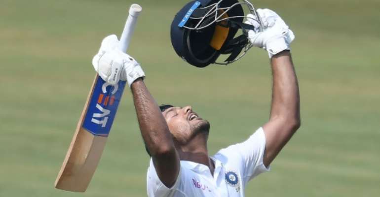 Indian cricketer Mayank Agarwal celebrates scoring 200 runs during the second day's play of the first Test match against South Africa. By NOAH SEELAM (AFP)