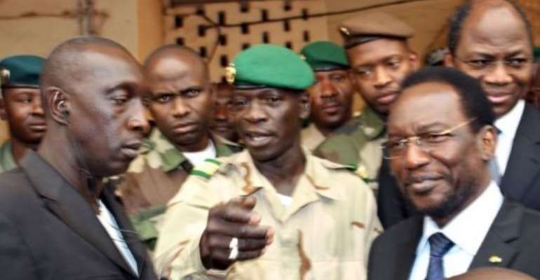 Mali's speaker of parliament Dioncounda Traore (R), with glasses) stands next to Captain Amadou Sanogo (C). By Habibou Kouyate (AFP)