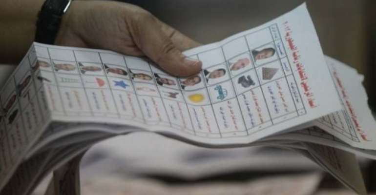 An Egyptian election official counts ballots at a polling station in Cairo. By Khaled Desouki (AFP/File)