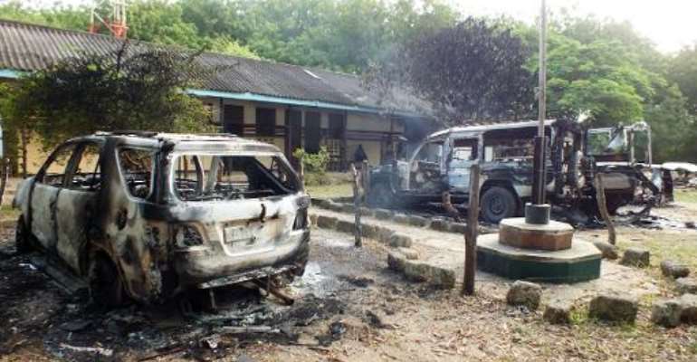 Charred vehicles sit outside a police station in Mpeketoni, in Lamu county along the Kenyan coast, after some 50 heavily-armed gunmen attacked the town near the coastal island and popular tourist resort of lamu the night before. By (AFP)