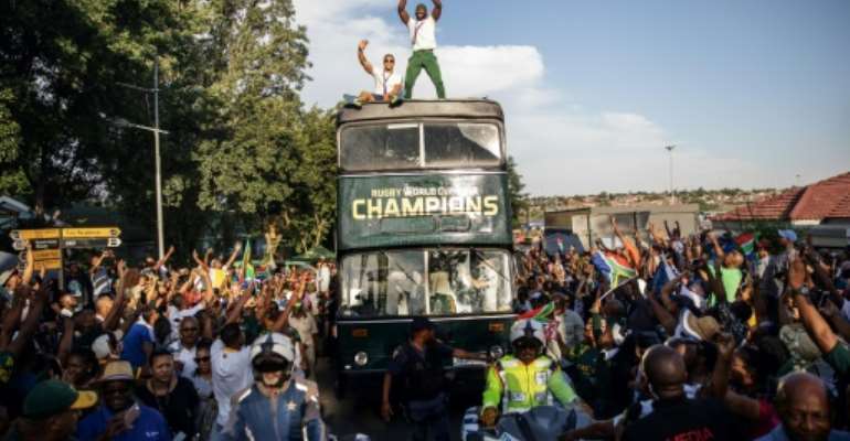 Kolisi stands proud on board the victory bus in Soweto. By Michele Spatari (AFP)