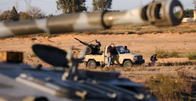 Members of the Tripoli Rebels Brigade militia patrol a main road in Tajura, 15 kms from the capital on November 16, 2013. By Mahmud Turkia (AFP/File)