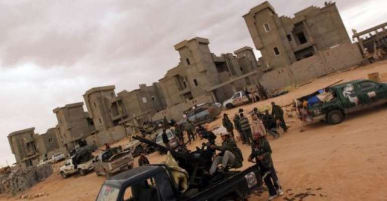 Libyan National Transitional Council (NTC) fighters gather at an outpost south of Bani Walid. By Karim Sahib (AFP/File)