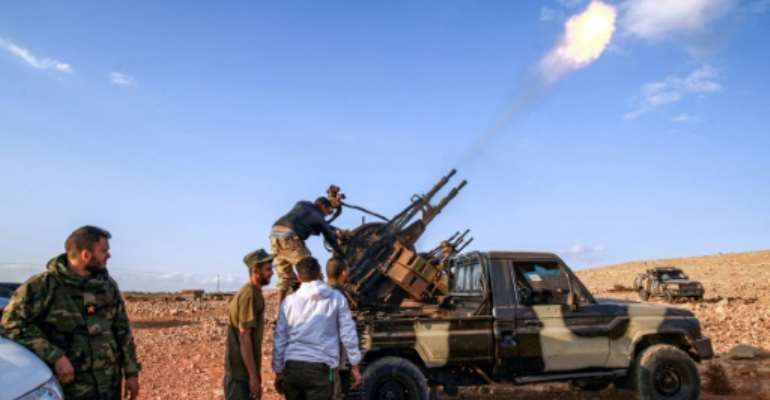Libyan fighters loyal to eastern strongman Khalifa Haftar fire guns during a funeral of a comrade in November 1, 2020; Haftar has urged his troops 'drive out' Turkish forces. By Abdullah DOMA (AFP)