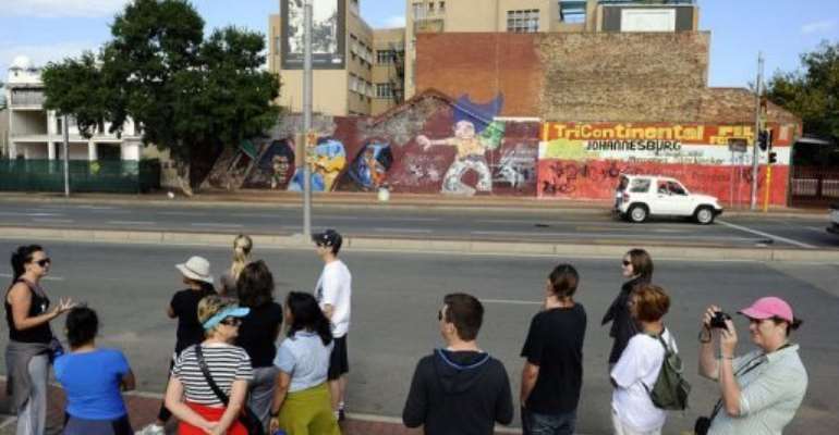 Toursits visit the Central Business District (CBD) of Johannesburg in March. By Stephane de Sakutin (AFP/File)