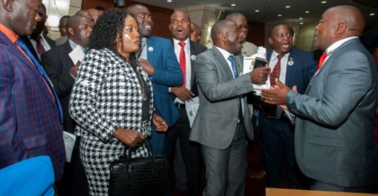 Malawi opposition members sang and danced as they sought to prevent President Peter Mutharika from delivering his state of the nation address.. By AMOS GUMULIRA (AFP)