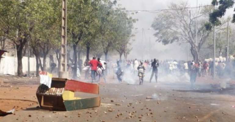 Supporters of Malian soldiers fighting Tuareg rebels, clash with security forces during a protest. By (AFP/File)