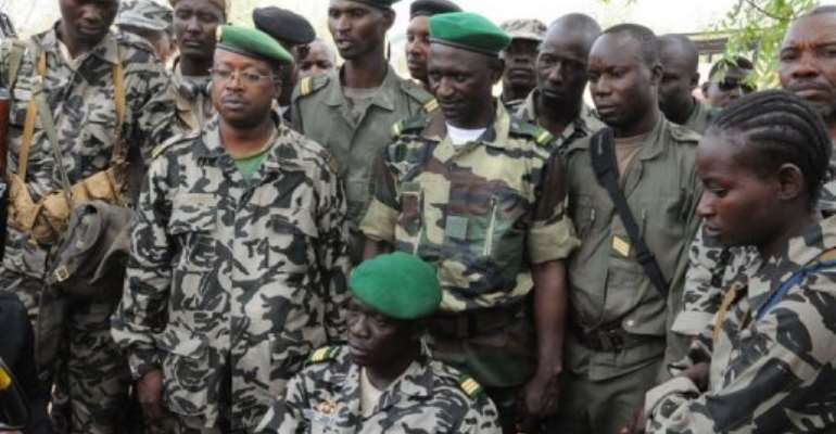 Mali junta leader Captain Amadou Sanogo (C) poses surrounded by his fellow soldiers. By Habibou Kouyate (AFP/File)