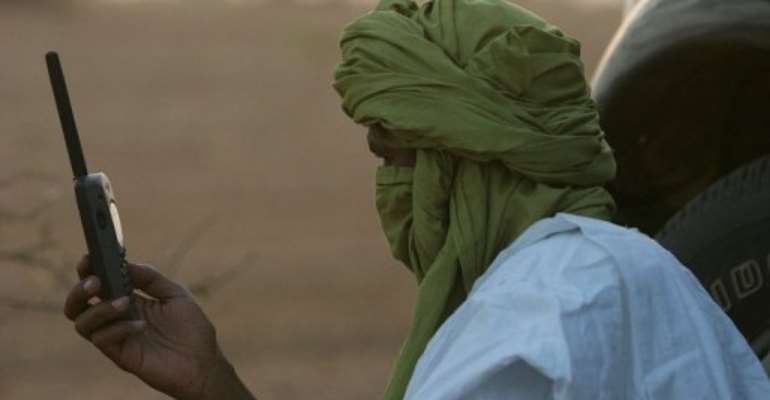 A Tuareg checks his satellite phone in the North Malian desert. By Georges Gobet (AFP/File)