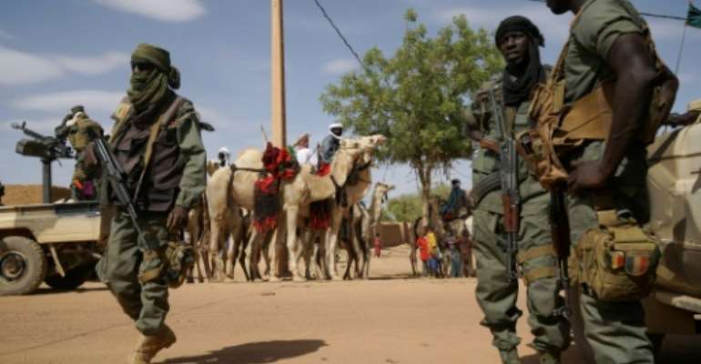 Malian soldiers on patrol in the city of Menaka, Mali in May 2018. By Sebastien RIEUSSEC (AFP/File)