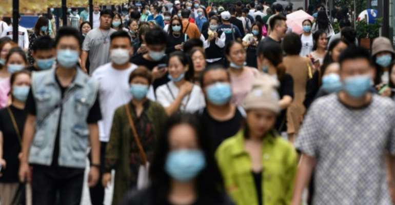 Many people in Wuhan, where the coronavirus first emerged, are still wearing masks despite there being no new cases since May. By Hector RETAMAL (AFP)
