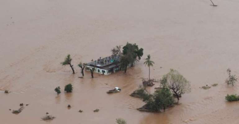 Many people survived the storm and flooding by climbing onto rooftops or up trees where they were waiting to be rescued. By Rick Emenaket (Mission Aviation Fellowship/AFP)