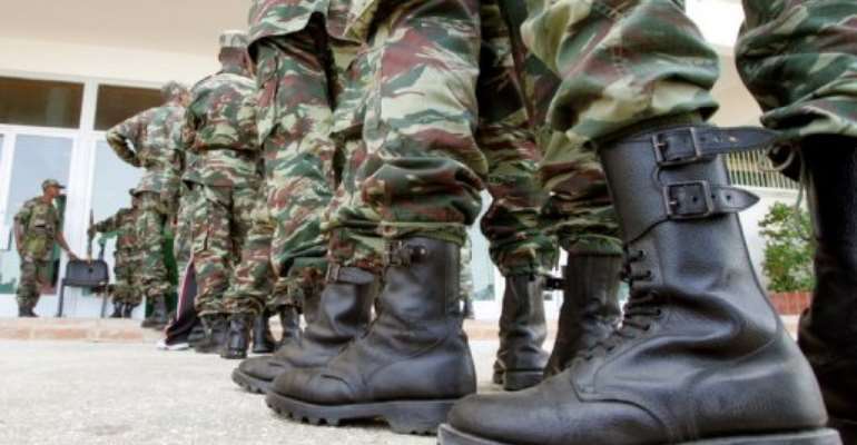 Mauritanian soldiers stand in line to vote at a polling center in Nouakchott on March 25, 2007. By Georges Gobet (AFP/File)