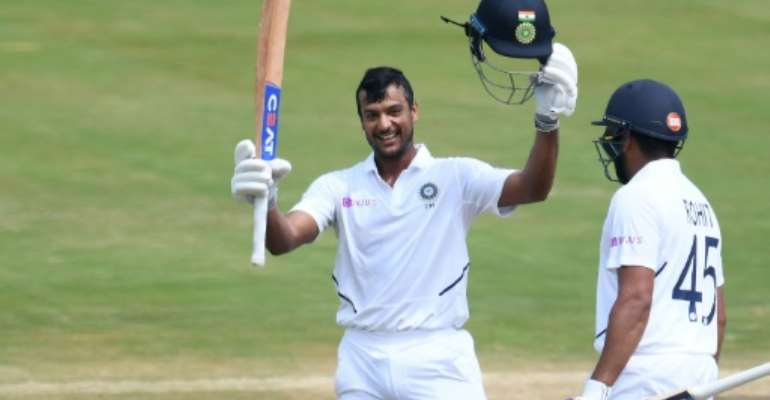 Mayank Agarwal raises his bat after reaching 100. By NOAH SEELAM (AFP)