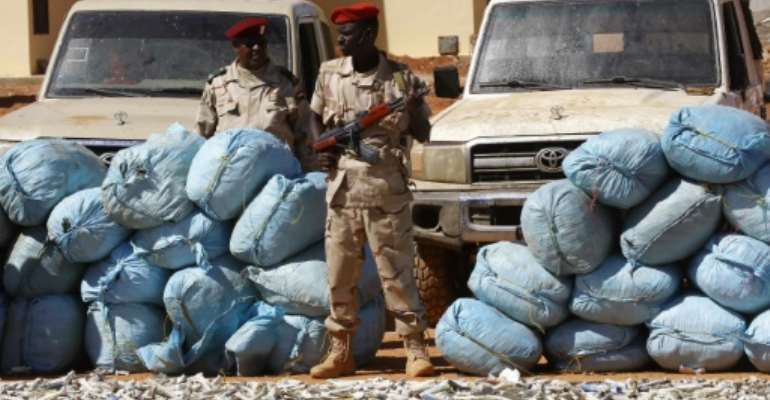 Members of Rapid Support Forces (RSF), Sudan’s controversial counter-insurgency unit, show on November 5, 2017 in Khartoum sacks of hashish that were captured in the state of South Darfur a week earlier. By ASHRAF SHAZLY (AFP)