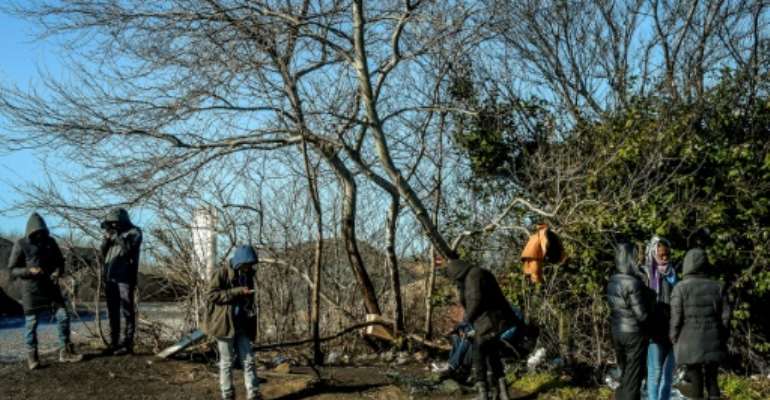 Migrants hoping to reach Britain on a road leading to the Calais harbour in northern France. By PHILIPPE HUGUEN (AFP)