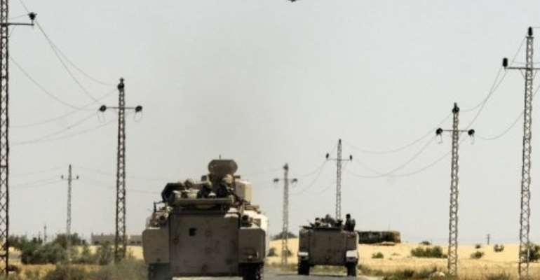Egyptian soldiers and a military helicopter are seen in the area near the Rafah border crossing, on May 21, 2013. By (AFP/File)