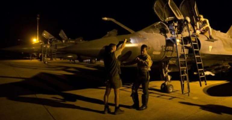 A French Mirage 2000 fighter jet pilot (L) on February 18, 2013, before taking off for a mission from Bamako's airport. By Joel Saget (AFP/File)