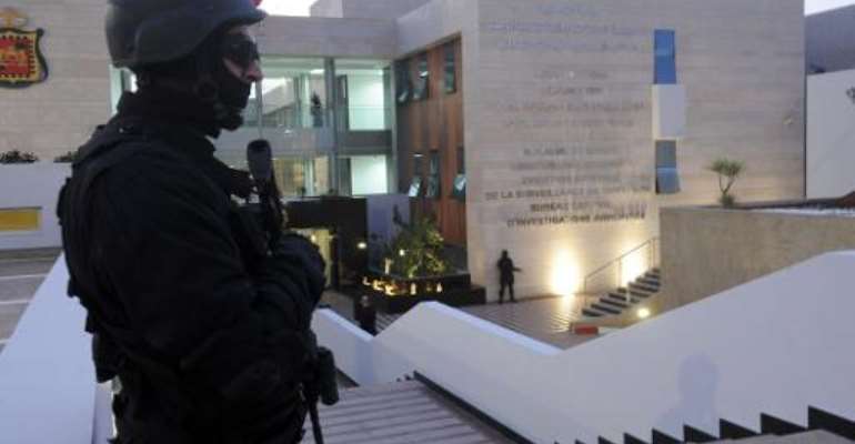 A member of the Moroccan special forces guard stands outside of the Central Bureau of Judicial Investigation (BCIJ) building on March 23, 2015 during a press conference by the governor of the BCIJ in Rabat. By (AFP/File)