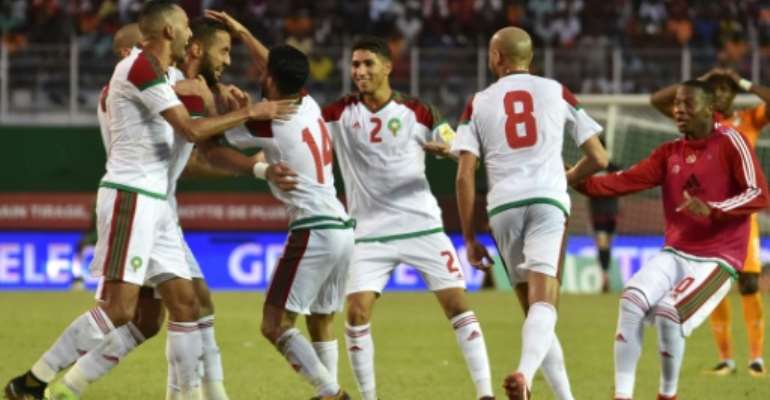 Morocco's team players celebrate a goal against Cote d'Ivoire at the Felix Houphouet-Boigny stadium in Abidjan on November 11, 2017. By ISSOUF SANOGO (AFP)