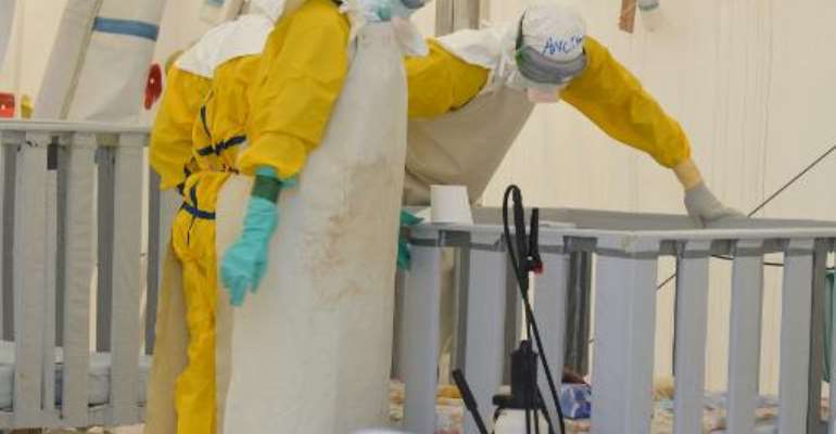 Health workers with 'Doctors Without Borders' wear protective gear whilst working at an Ebola treatment centre in the Liberian capital Monrovia on January 27, 2015. By Zoom Dosso (AFP/File)