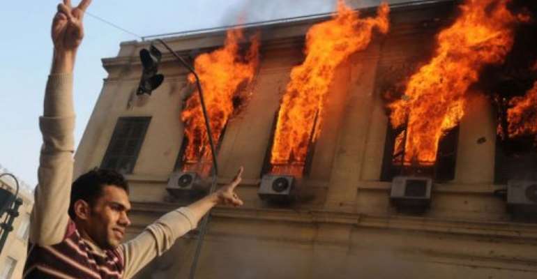 An Egyptian demonstrator makes victory signs. By Mohammed Hossam (AFP)