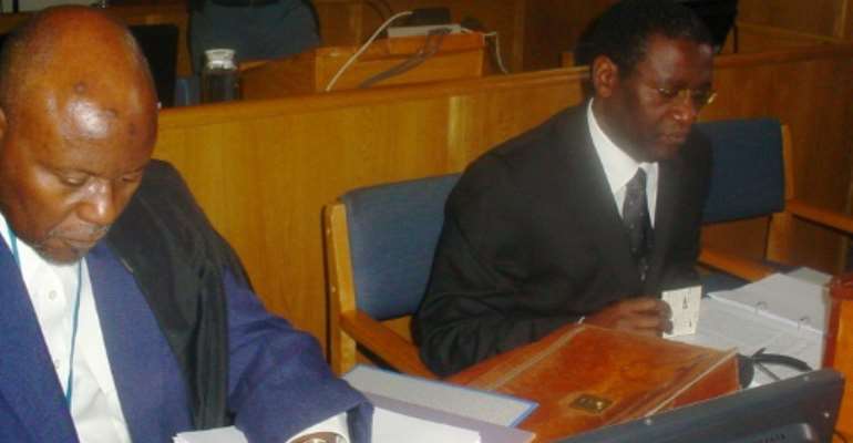 Ngirabatware, right, seated next to his lawyer at the start of his trial in 2008. By EPHREM RUGURIRIZA (AFP)