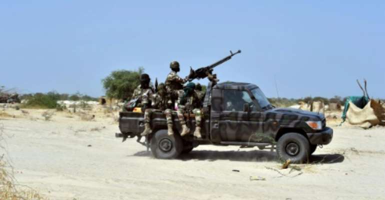 Niger soldiers ride in a military vehicle on May 25, 2015 in Malam Fatori. By Issouf Sanogo (AFP/File)