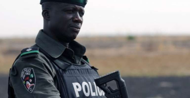 A Nigerian policeman patrols in the north of Borno state on June 5, 2013 near Maiduguri. By Quentin Leboucher (AFP/File)