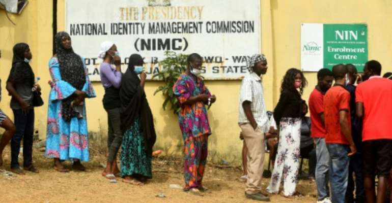 Nigerians queue to obtain the precious National Identity Number -- without it, their mobile phone may be cut off. By PIUS UTOMI EKPEI (AFP)
