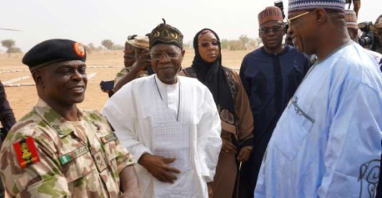 Nigeria's information minister Lai Mohammed (C) described the killing of an aid worker by Boko Haram as