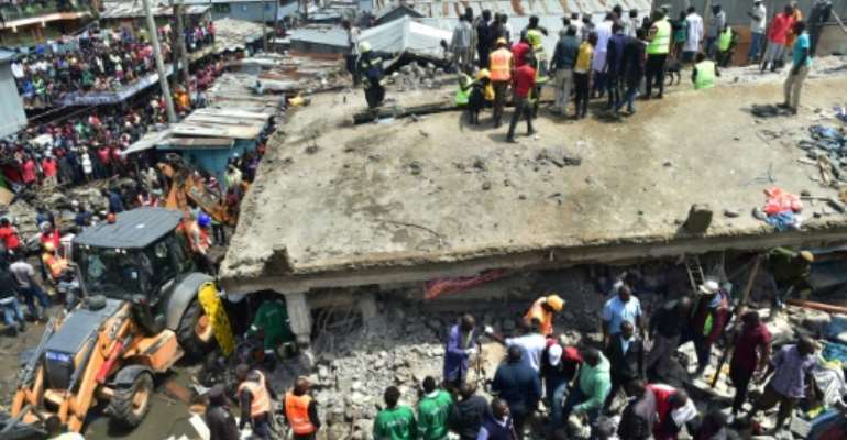 Onlookers swarmed the twisted ruins of the six-floor building, using their bare hands to pull out injured people. By Simon MAINA (AFP)
