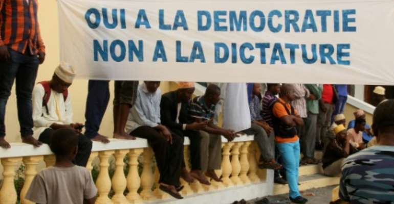 Opposition supporters hold a banner saying 'Yes to democracy, no to dictatorship'. By Youssouf IBRAHIM (AFP)